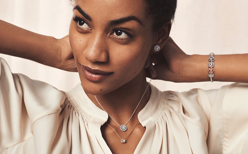 Model wearing Pandora Timeless necklaces, bracelet and earrings.