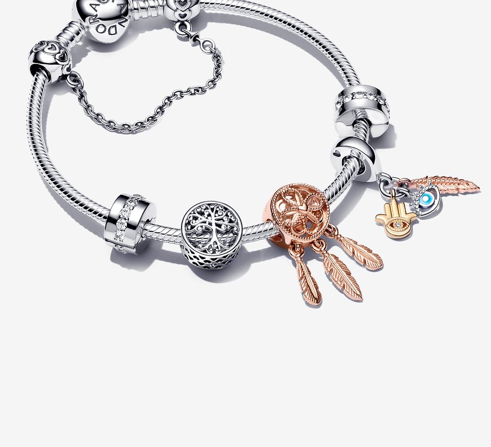 Sterling silver bracelet with silver and rose gold charms and a silver safety chain
