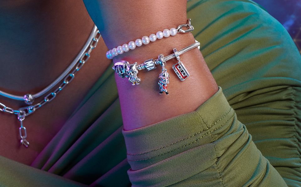 Model wearing Marvel x Pandora sterling silver necklaces and bracelets