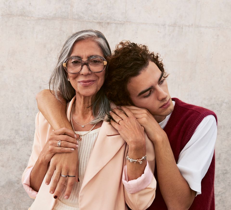 Son embraces mother who is wearing Pandora Mother's Day jewellery