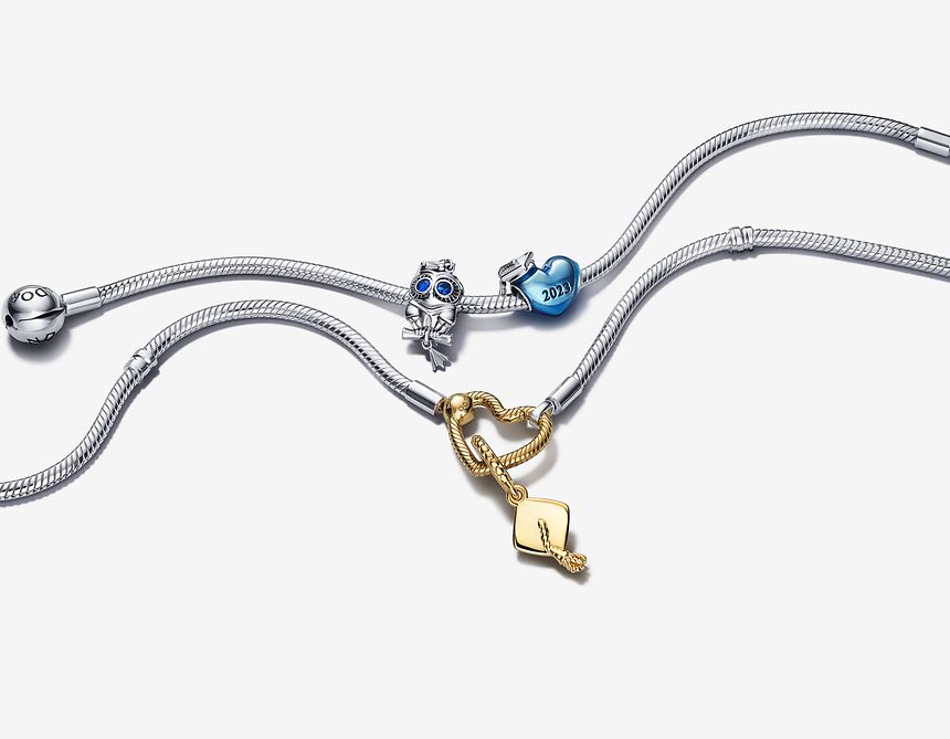 Two silver charm bracelets, with 3 silver, blue and gold achievement charms