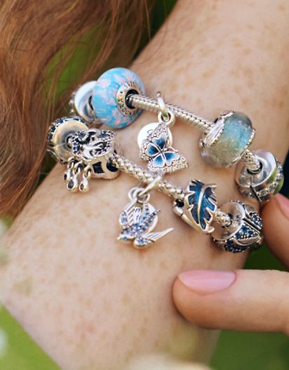 Model wearing Pandora Moments spring charm bracelets with flowers