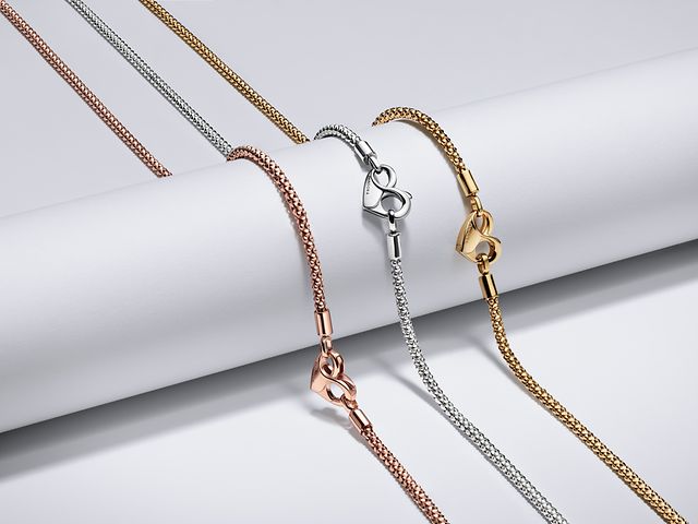 Bild av tre pärlade halsband ur Pandora Moments-kollektionen i silver, guld och roséguld.