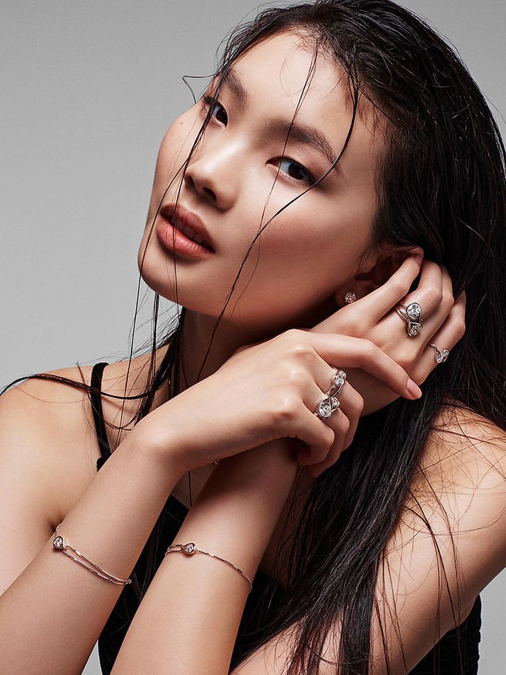 Woman wearing several Pandora infinite rings and two bracelets.