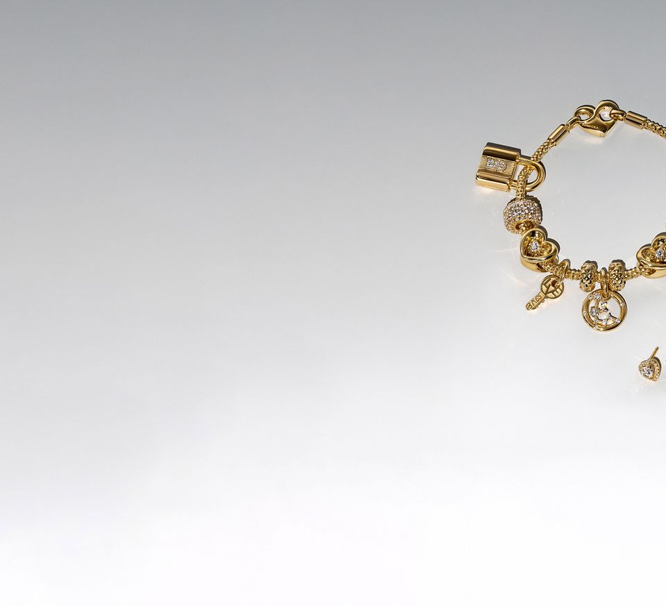 Image of pandora BE LOVE gold and lab diamond charm bracelet and five earrings