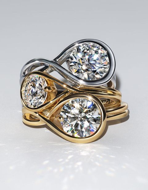 Image of 2 lab-grown diamond rings; 1 silver and 1 gold, on top of each other