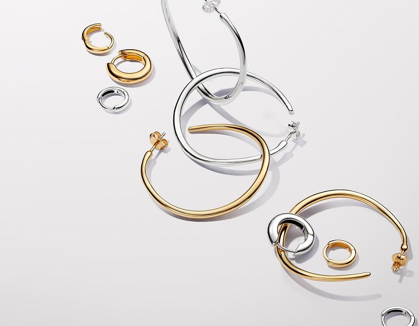 Pandora Essence gold and silver hoop earrings.
