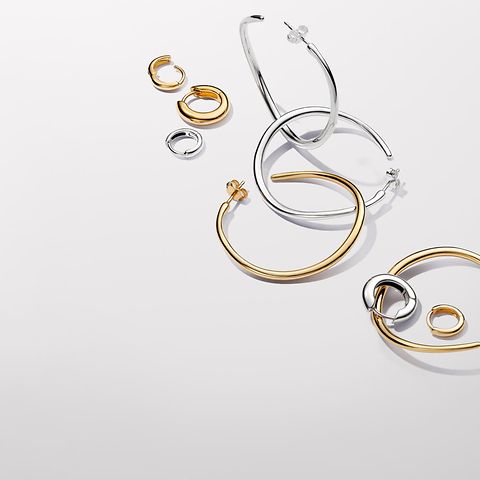 Pandora Essence gold and silver hoop earrings.